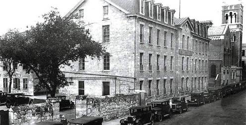 A black and white photo of a building
Description automatically generated